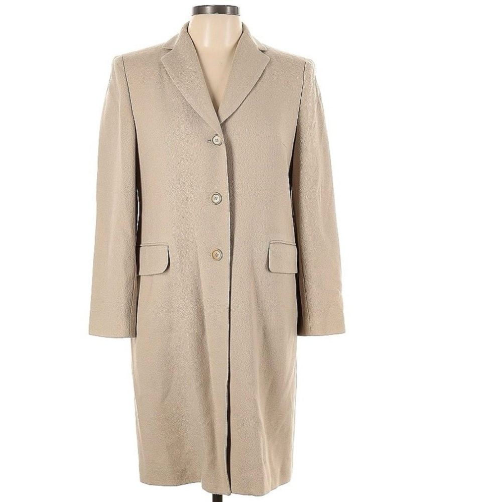 100% wool shell. Fits Sm/md well, would be a great long coat on a petite frame